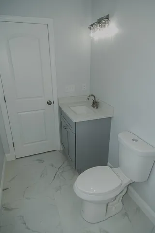 a white toilet sitting next to a bathroom sink