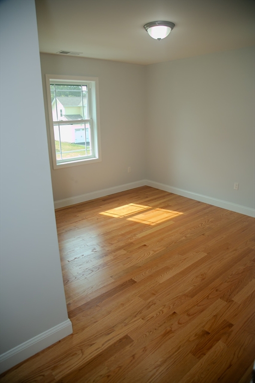 99 West Crystal Brook Drive Springfield, MA 01118 - Photo 31 of 40 an empty room with wooden floor and windows
