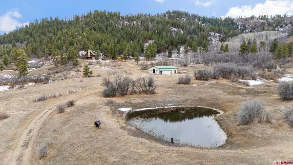 an aerial view of a house with a yard
