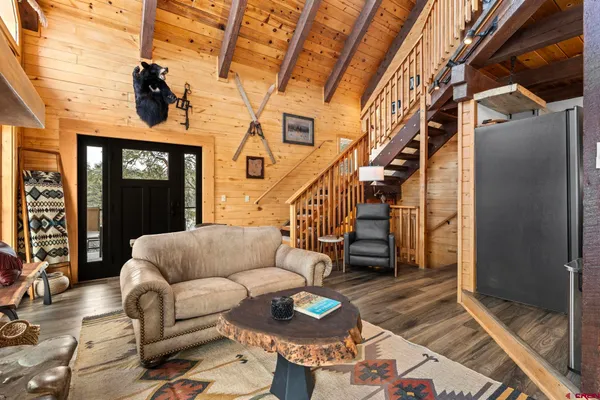 a living room with furniture a fireplace and a flat screen tv