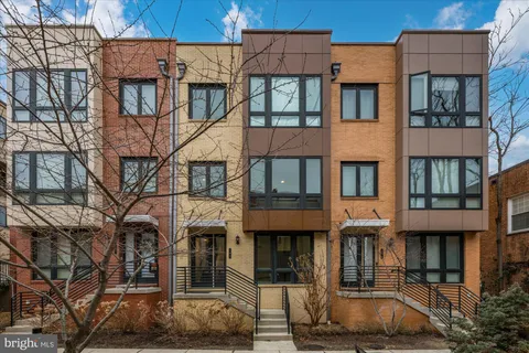 a front view of a residential apartment building with a yard