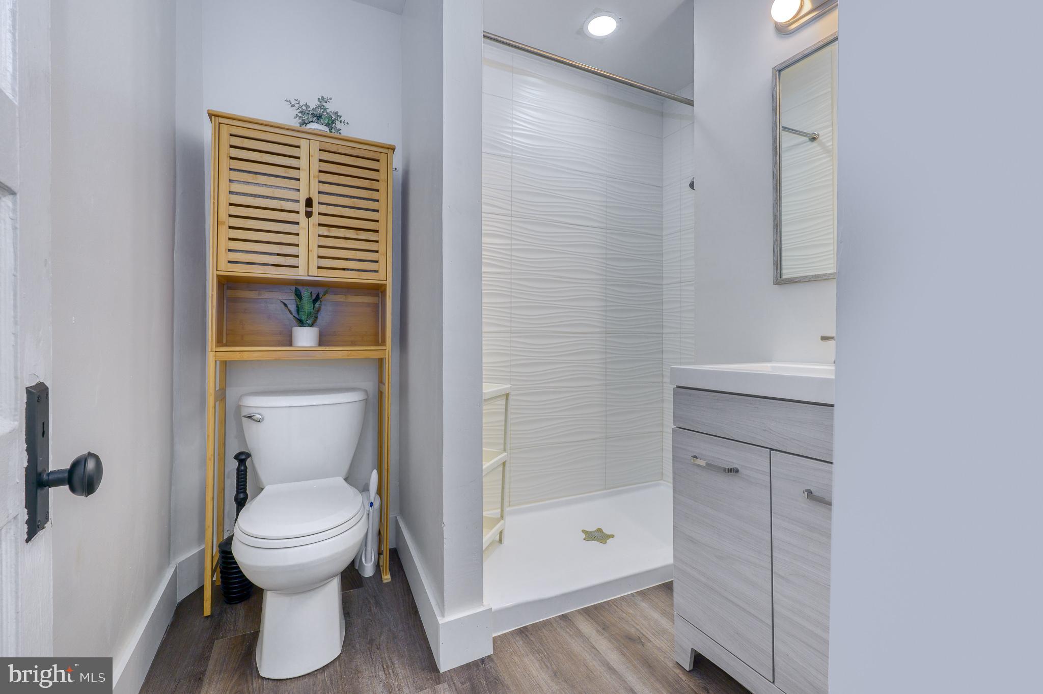 7104 Harford Road Baltimore, MD 21234 - Photo 19 of 37 a bathroom with a toilet and a shower
