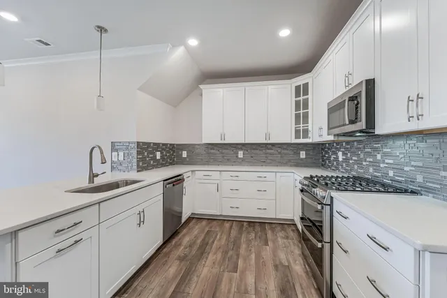 a kitchen with a sink stove and cabinets