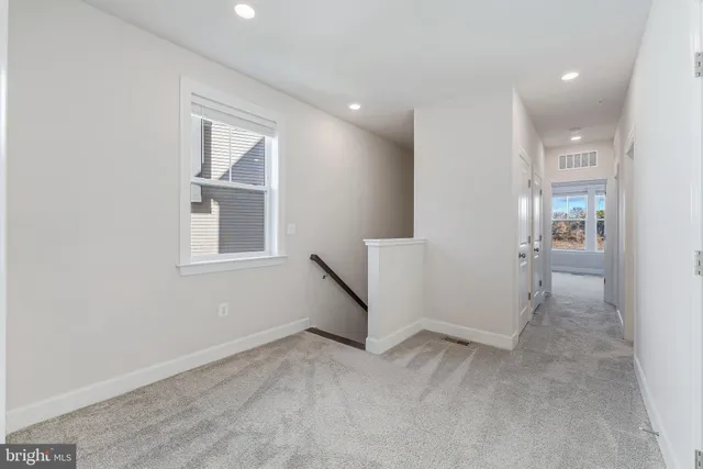 an empty room with windows and entrance