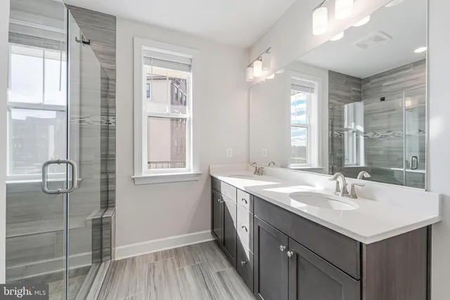 a bathroom with a sink double vanity and a mirror