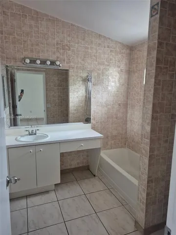 a bathroom with a bathtub and a sink