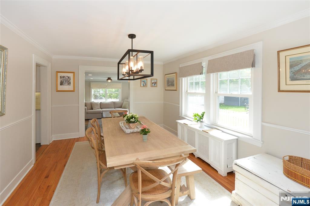570 Shelton Road Ridgewood, NJ 07450 - Photo 6 of 26 a view of a dining room with furniture a chandelier and wooden floor