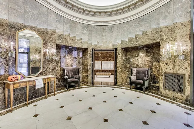 a view of a hallway with wooden floor and a large window