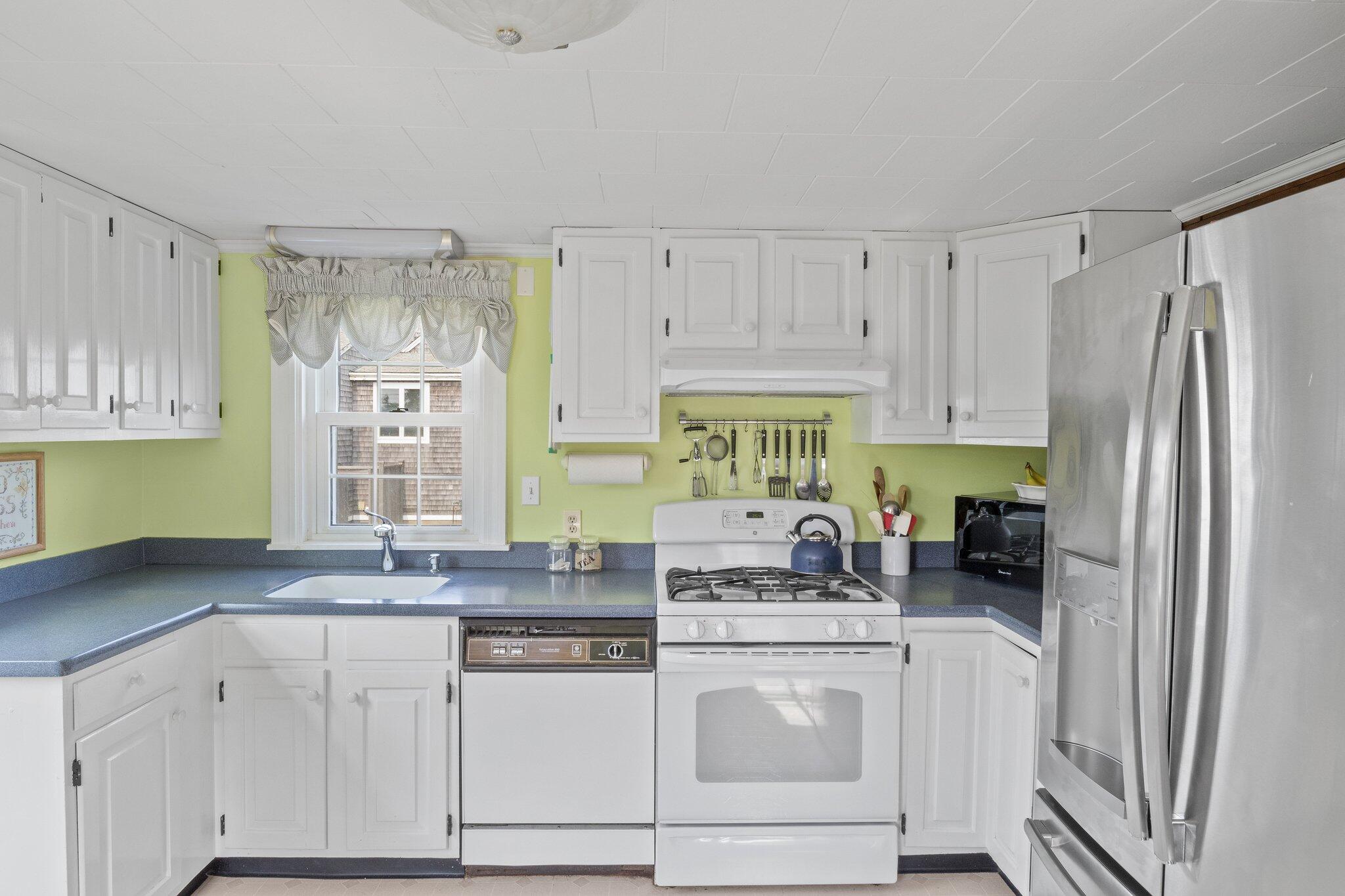 103 Long Beach Road Centerville, MA 02632 - Photo 15 of 36 a kitchen with stainless steel appliances granite countertop a refrigerator sink and cabinets