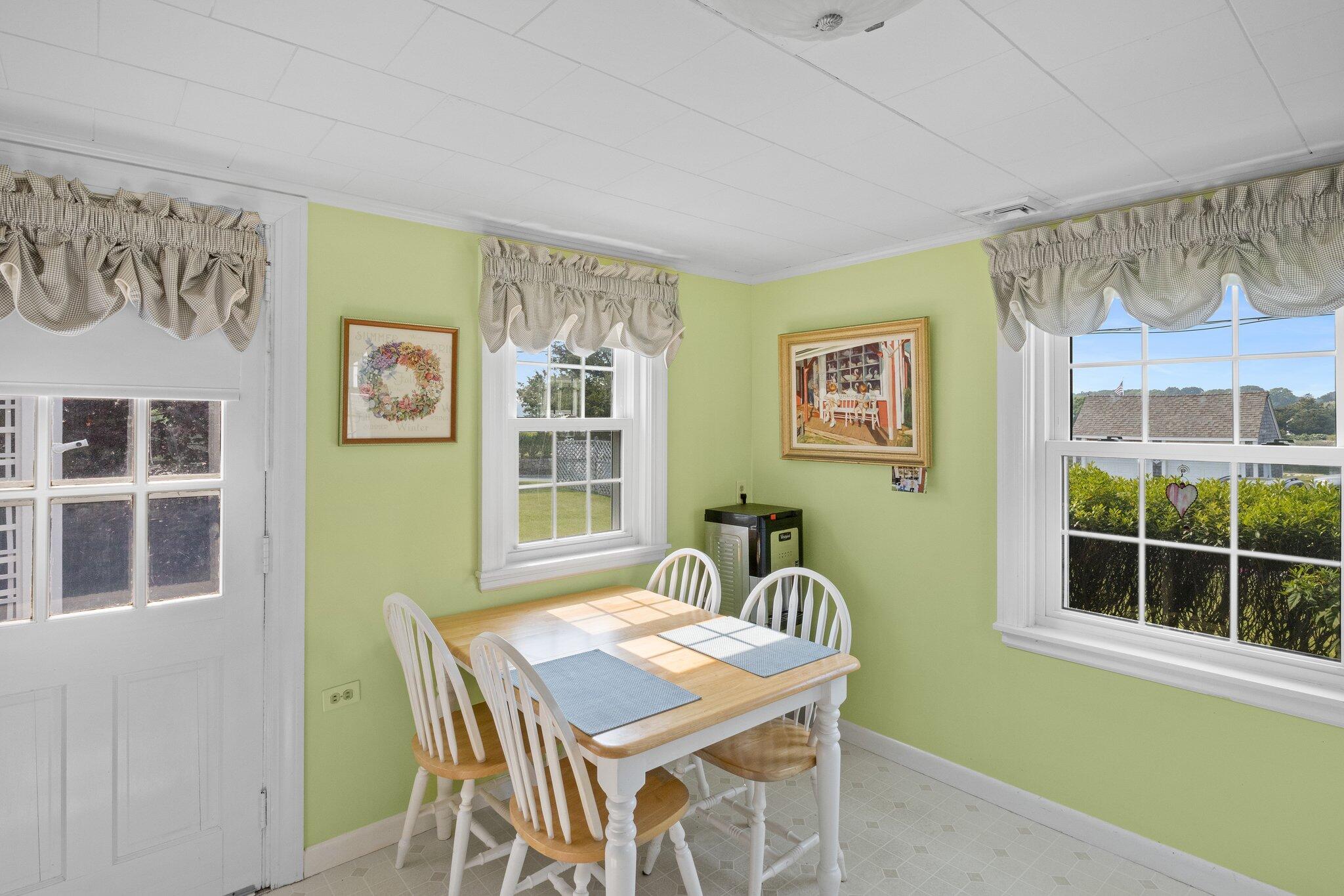 103 Long Beach Road Centerville, MA 02632 - Photo 16 of 36 a view of a dining room with furniture and windows