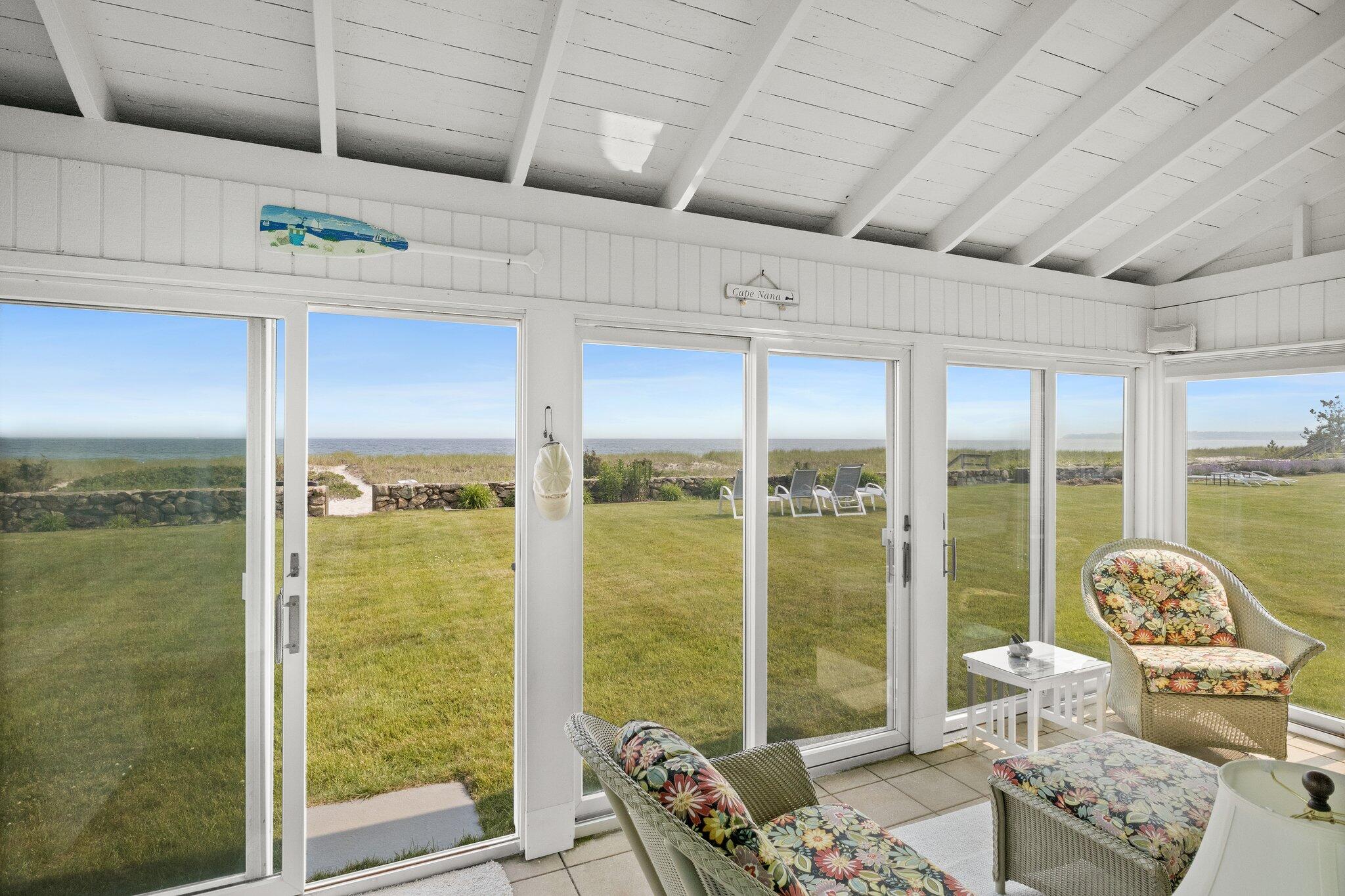 103 Long Beach Road Centerville, MA 02632 - Photo 17 of 36 a living room with furniture and a floor to ceiling window