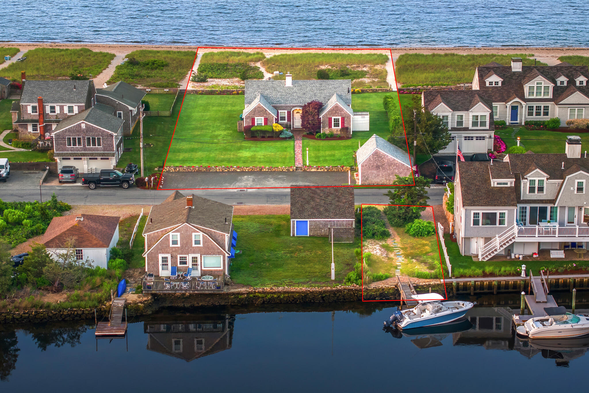 103 Long Beach Road Centerville, MA 02632 - Photo 3 of 36 an aerial view of a house with a garden and swimming pool