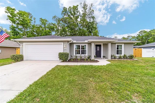 a front view of house with yard and green space