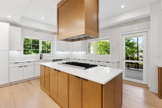 a kitchen with a stove a sink and a refrigerator