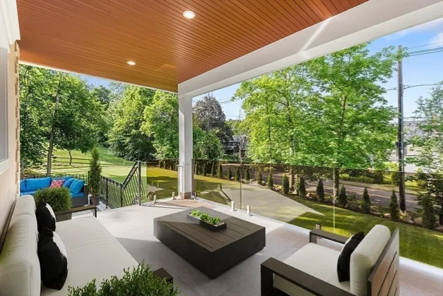 a view of a patio with couches chairs potted plants and a big yard