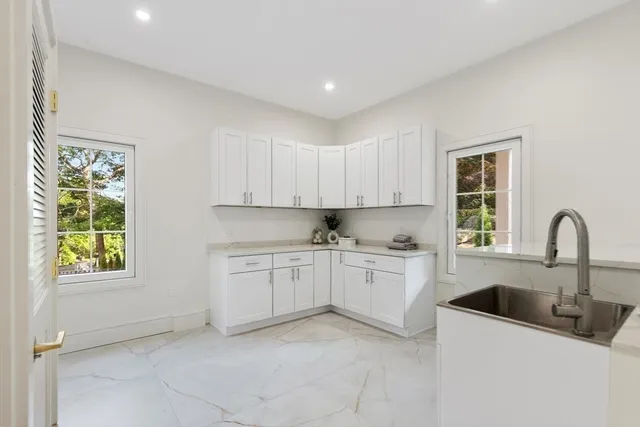 a kitchen that has a sink and a stove in it