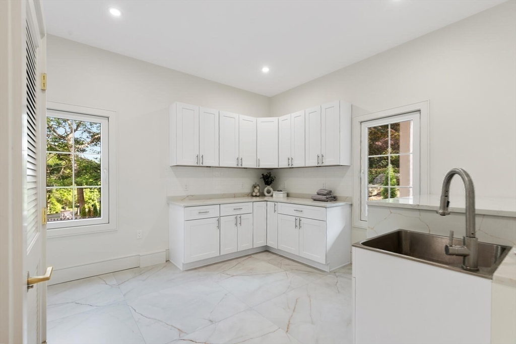 58 Chestnut Street Lynnfield, MA 01940 - Photo 15 of 42 a kitchen that has a sink and a stove in it