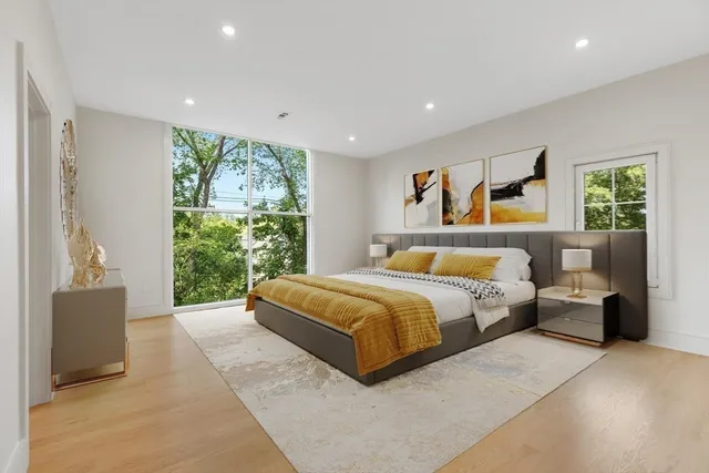 a spacious bedroom with a large bed and a couch