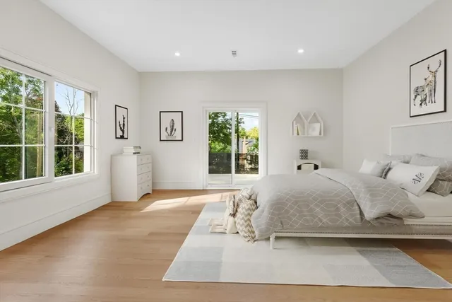 a bedroom with a large bed and a window