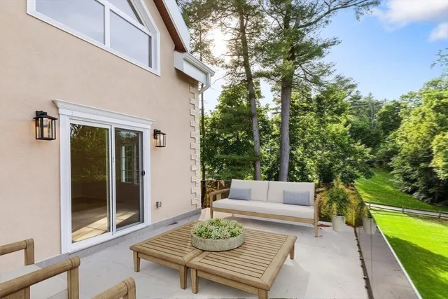 a view of a patio with couches table and chairs and potted plants