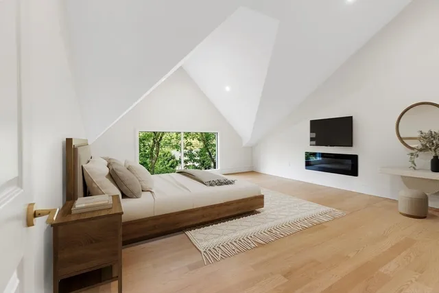 a bedroom with a bed and glass wall