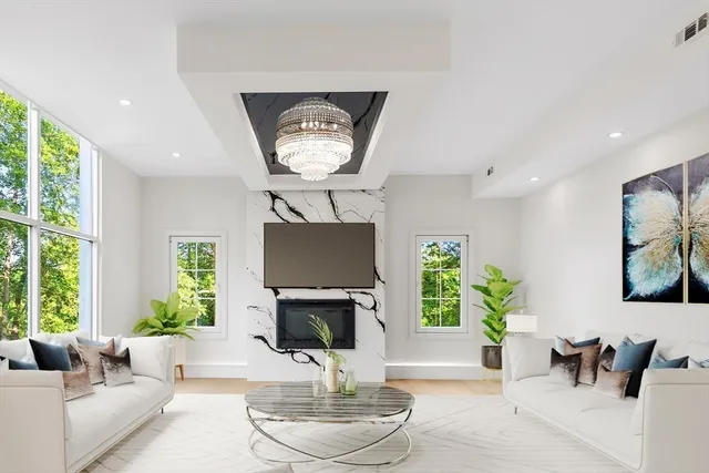 a living room with furniture a window and a fireplace