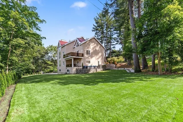 a sign that is sitting in front of a tree