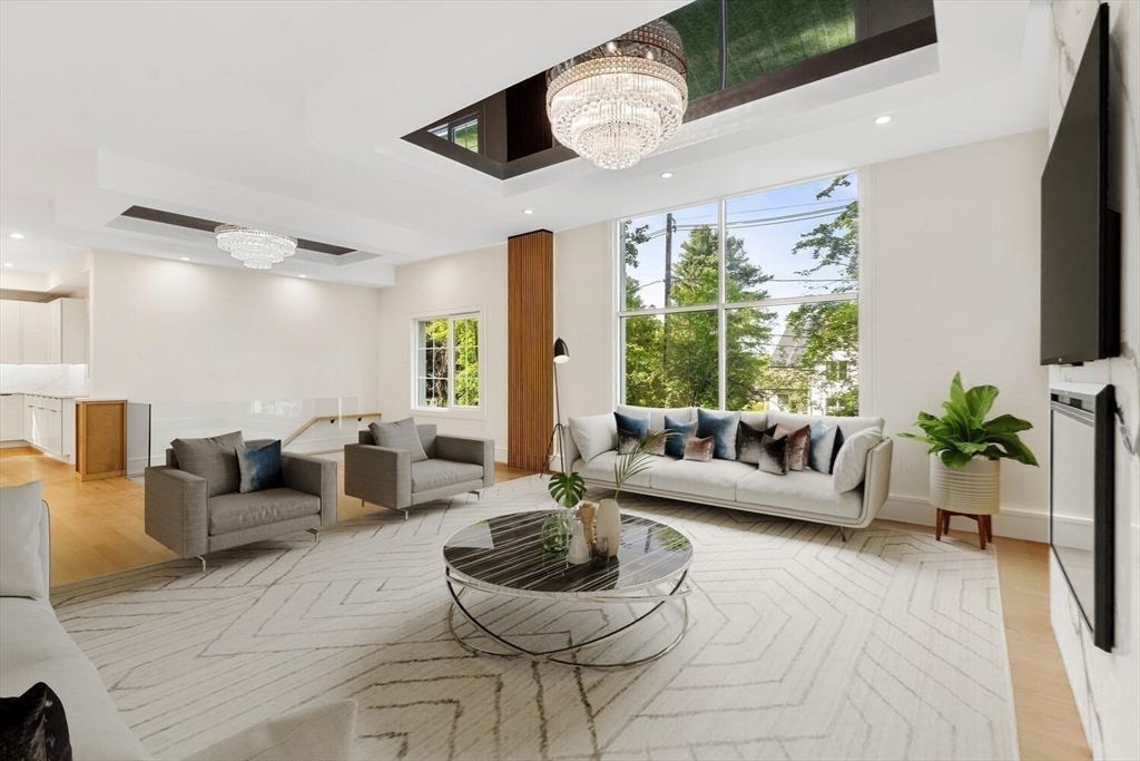 58 Chestnut Street Lynnfield, MA 01940 - Photo 4 of 42 a living room with furniture a flat screen tv and a large window