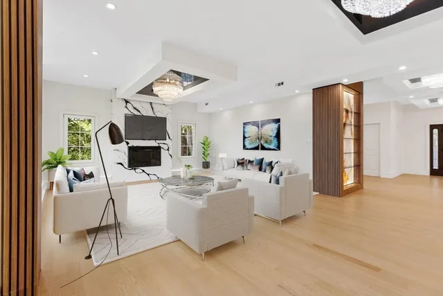 a living room with fireplace furniture and a flat screen tv