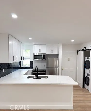 a kitchen with refrigerator and cabinets