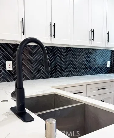 a large kitchen with a large counter top appliances and cabinets