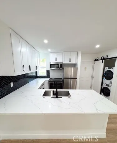 a bathroom with a tub sink mirror and toilet