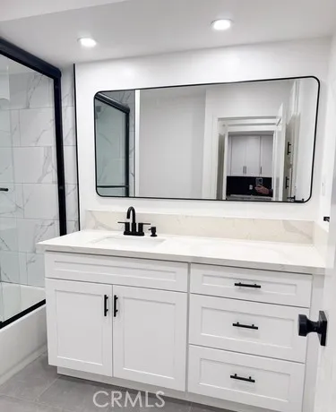 a bathroom with a double vanity sink and mirror