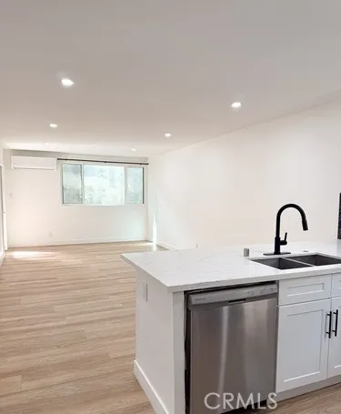 a view of a kitchen with sink and wooden floor