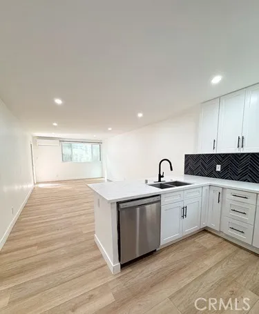 a kitchen with a sink and cabinets