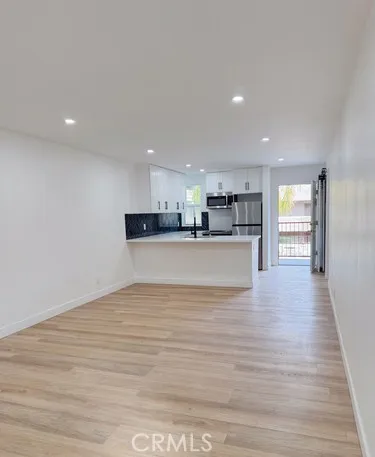 a view of kitchen and kitchen with stainless steel appliances
