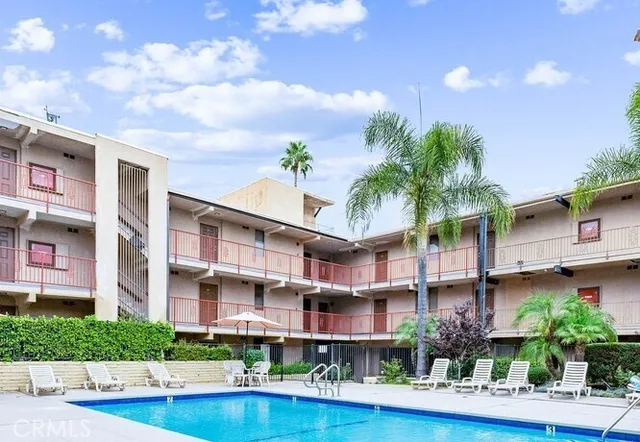 a front view of a residential apartment building with a yard