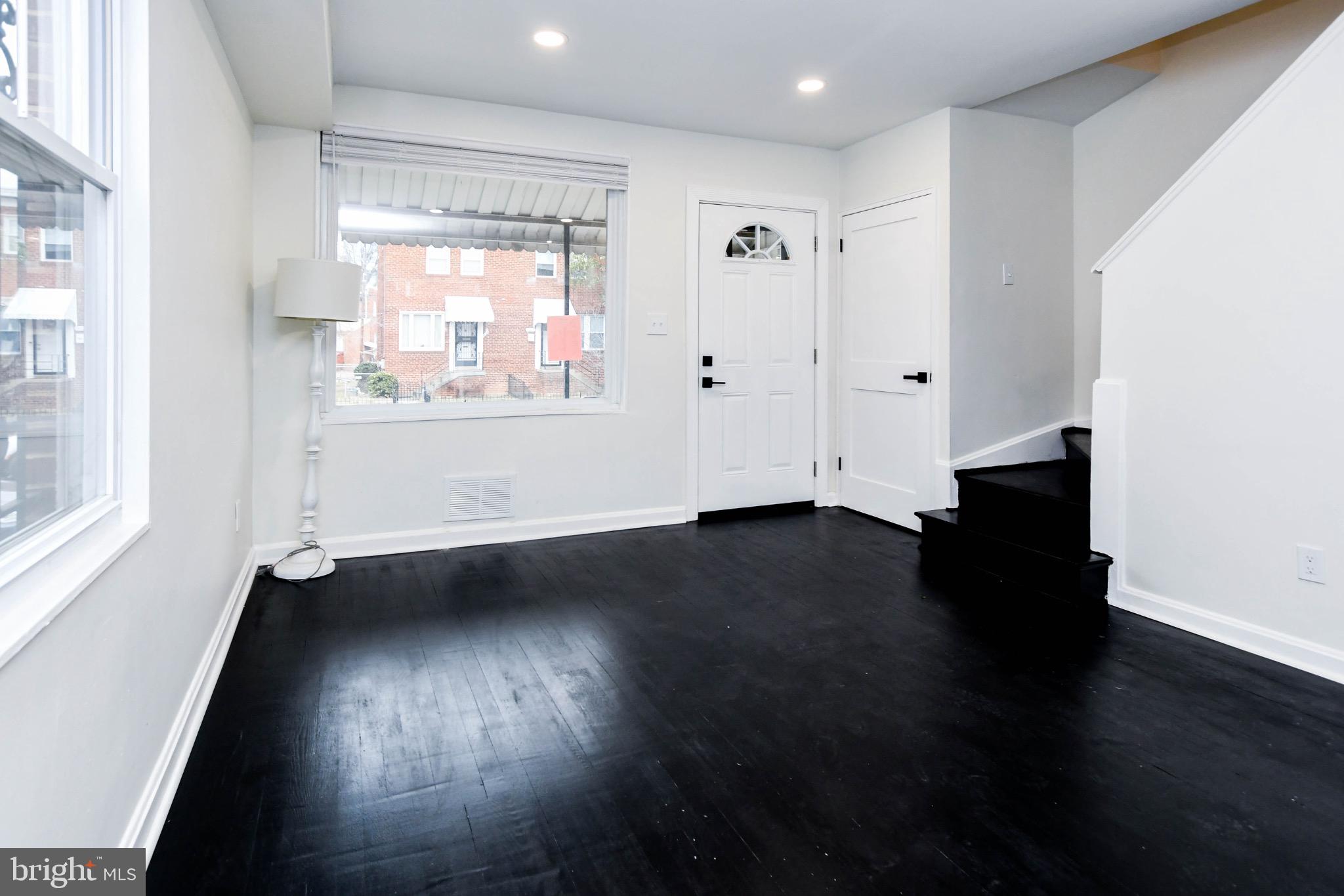 4227 Nash Street Southeast Washington, DC 20020 - Photo 2 of 13 an empty room with wooden floor and windows