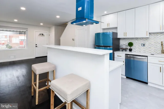 a kitchen with a table chairs refrigerator and microwave