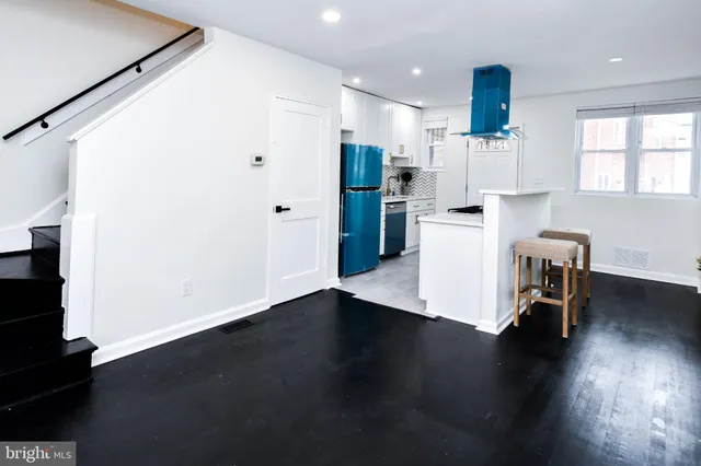 a view of kitchen with stainless steel appliances refrigerator microwave and stove