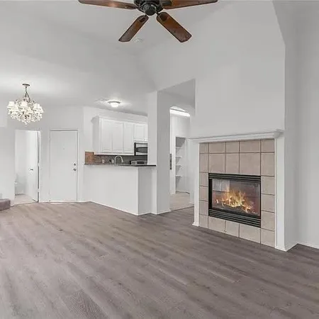 a view of an empty room with a fireplace