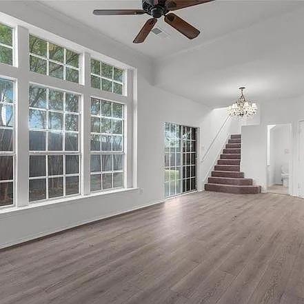 1908 Nest Place Plano, TX 75075 - Photo 7 of 14 a view of an empty room with wooden floor and windows
