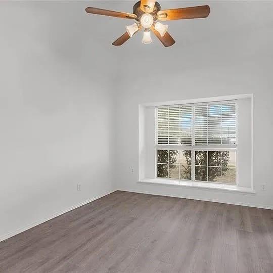 1908 Nest Place Plano, TX 75075 - Photo 9 of 14 a view of an empty room with wooden floor and a window