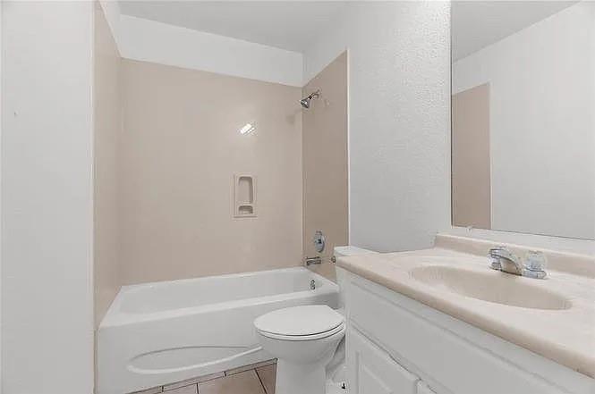 1908 Nest Place Plano, TX 75075 - Photo 10 of 14 a bathroom with a sink a toilet and a bathtub