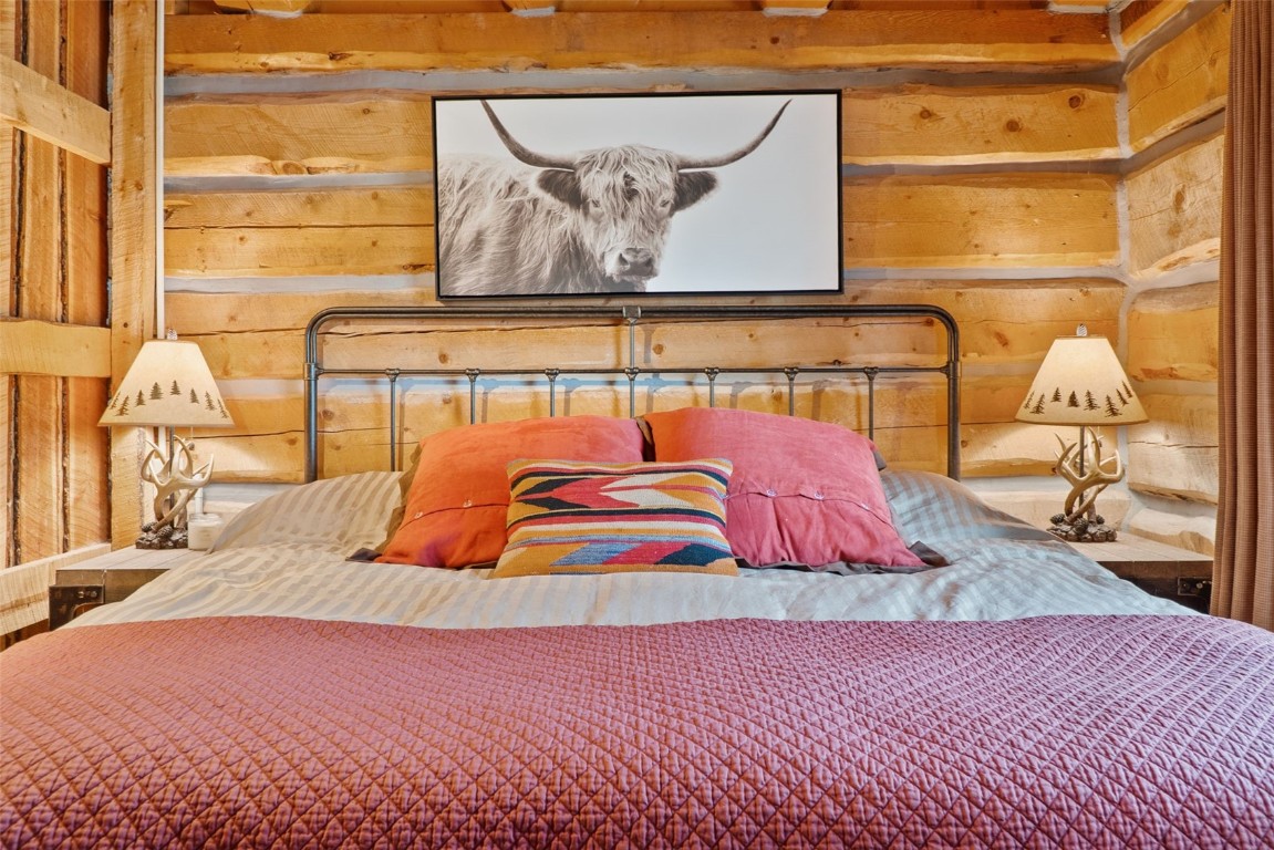 245 Bronco Circle Como, CO 80456 - Photo 22 of 40 a bedroom with a bed and painting on the wall