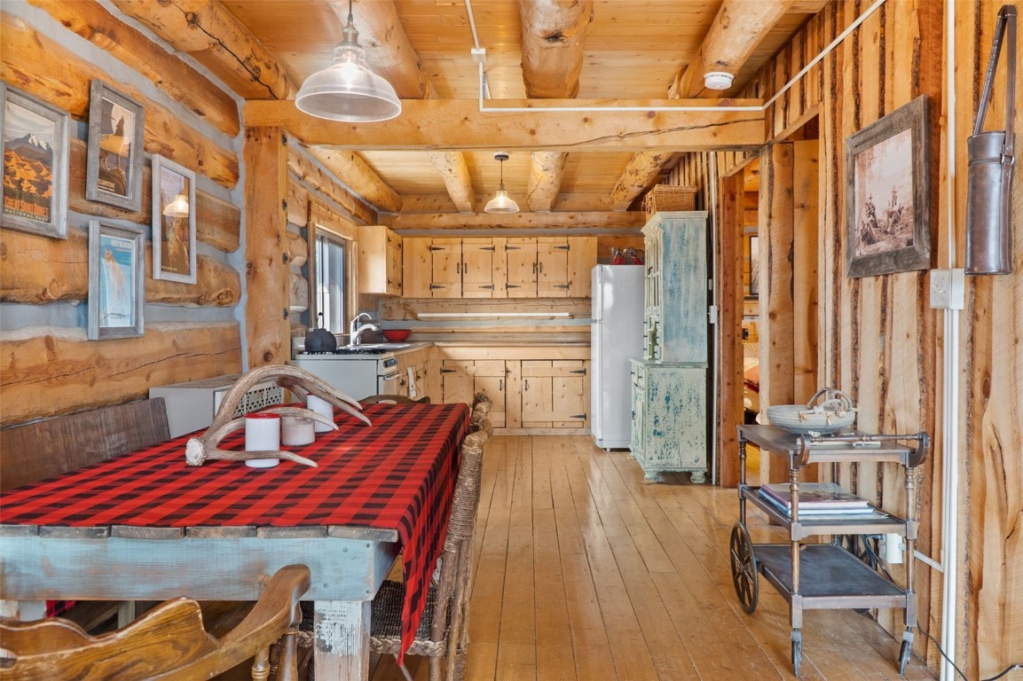 245 Bronco Circle Como, CO 80456 - Photo 9 of 40 a view of a dining room with furniture a chandelier and wooden floor