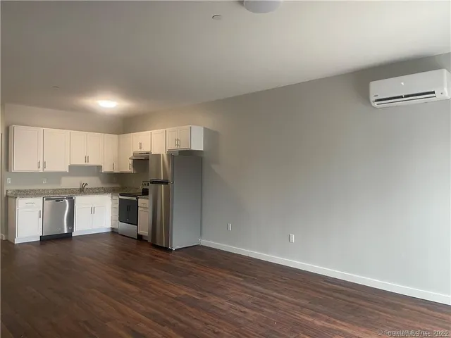 a kitchen with a refrigerator sink and cabinets