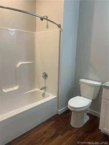 a bathroom with a toilet and a bathtub