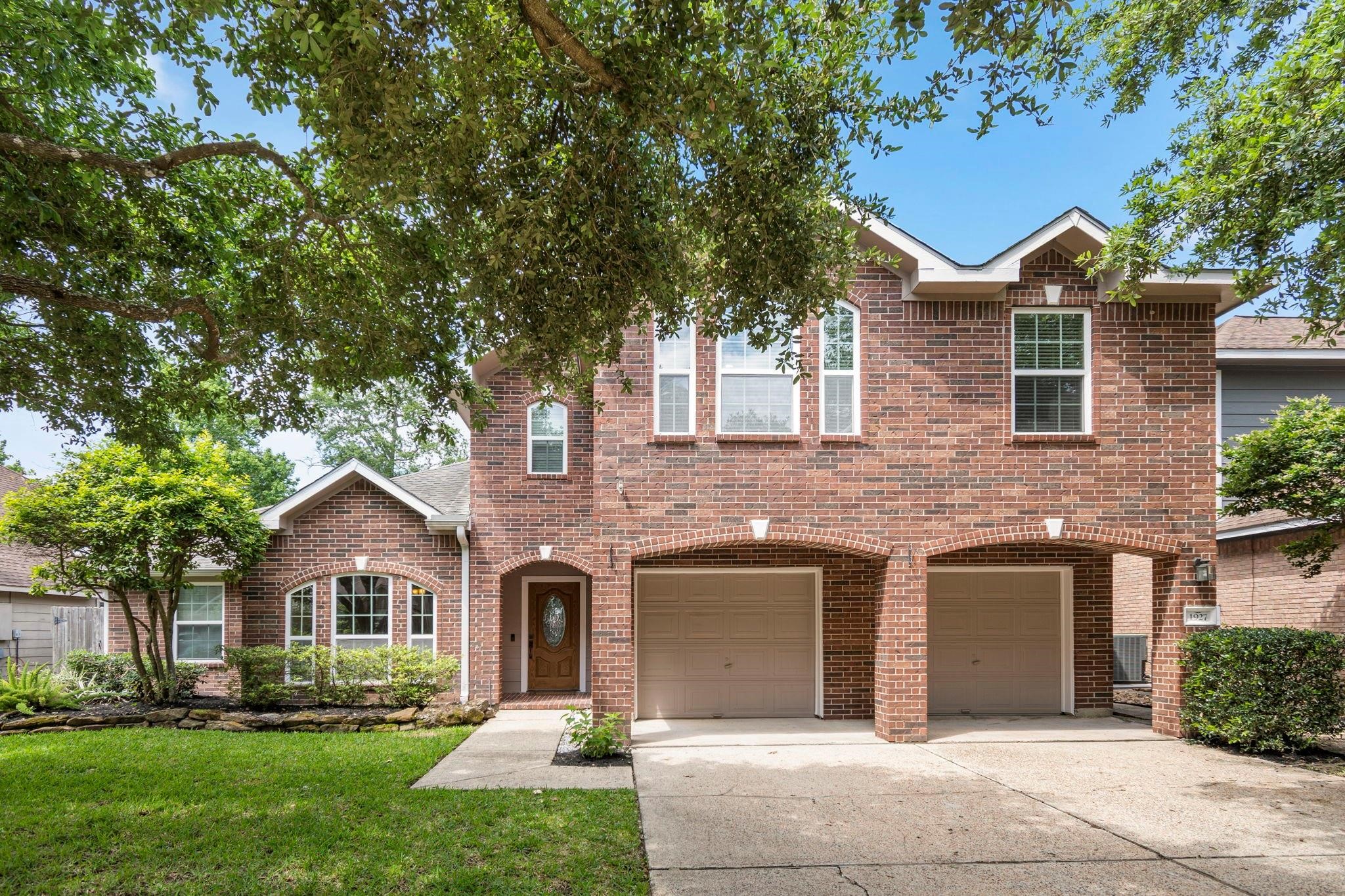 1927 Enchanted Park Drive Spring, TX 77386 - Photo 2 of 11 front view of a house with a yard