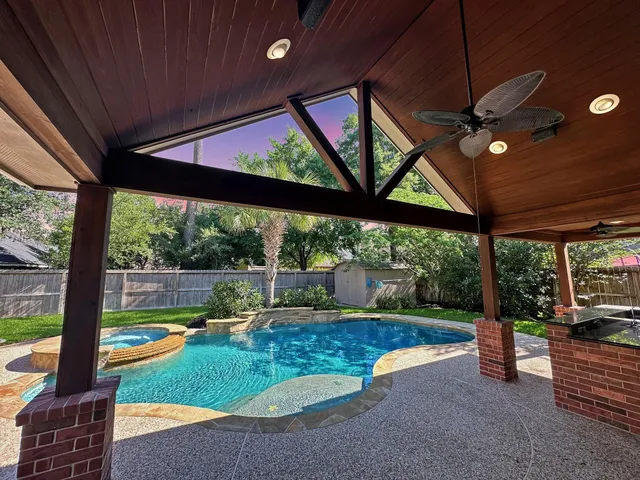 a view of swimming pool with a patio